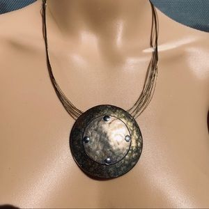 Boho, large  metal disc suspended on 20” necklace
